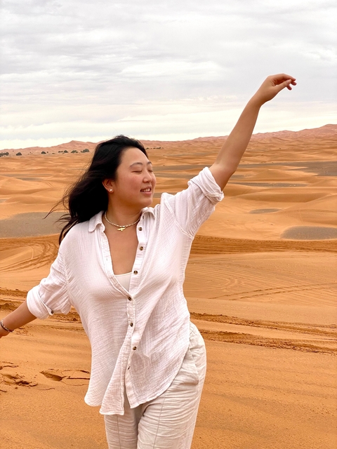       Woman posing in a desert landscape.
  