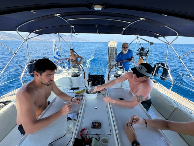 People on a sailing boat enjoying sunny weather.