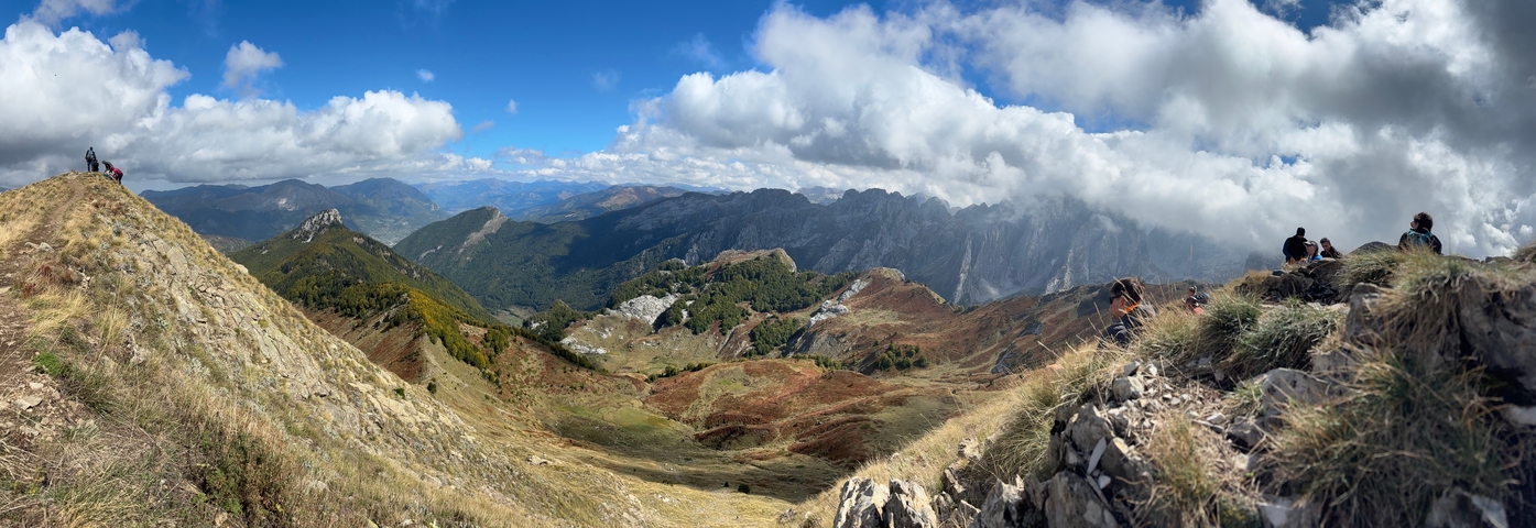 Scenic mountain range with clouds casting shadows.