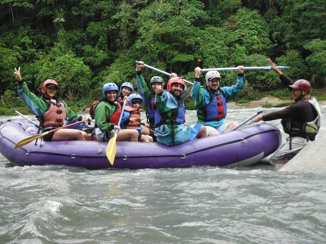 Group of people in a raft enjoying white-water rafting.