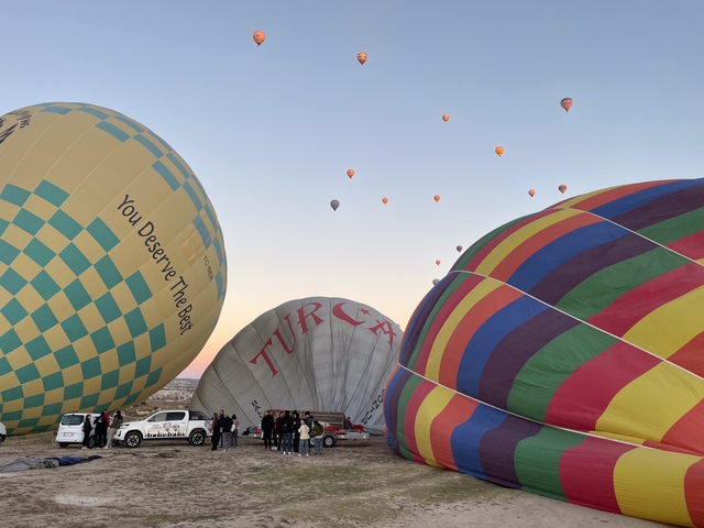 Hot air balloons being inflated on the ground.