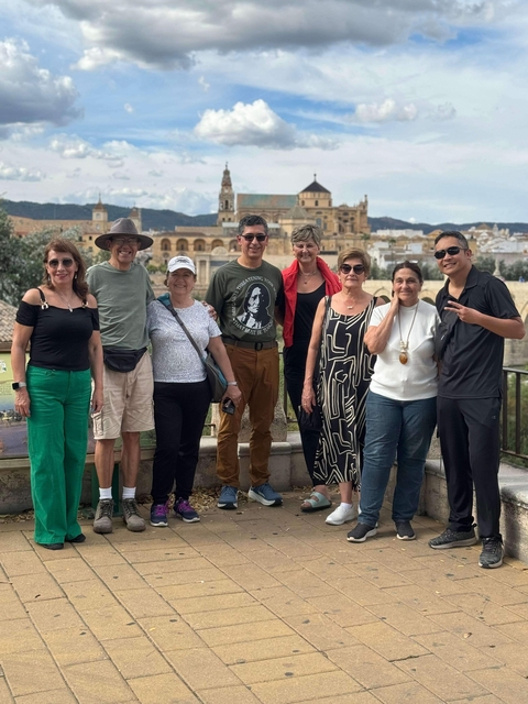 Group of people posing with a view of an ancient city