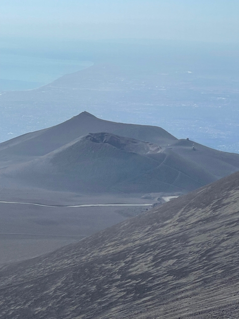       Volcanic landscape with craters and rocky terrain
  