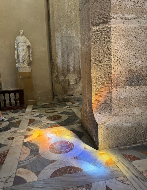       Interior of an ancient stone building with patterns on the floor
  