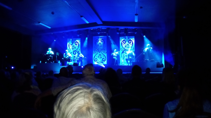       A stage performance with blue lighting.
  