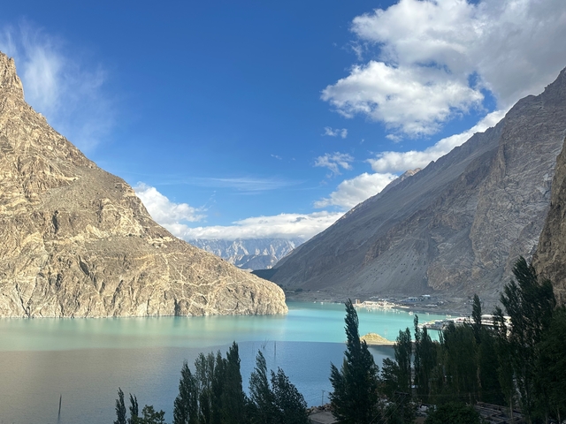 Turquoise lake with towering rock formations.