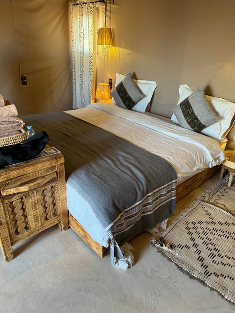       Comfortable bed in a well-decorated room.
  