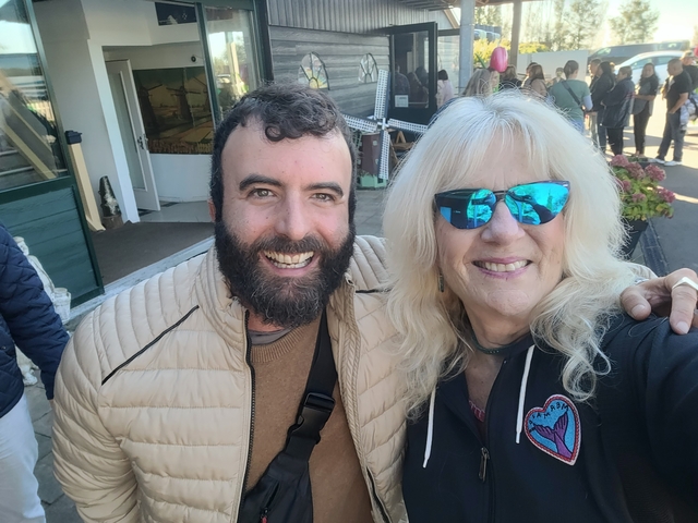       Two happy people taking a selfie together.
  