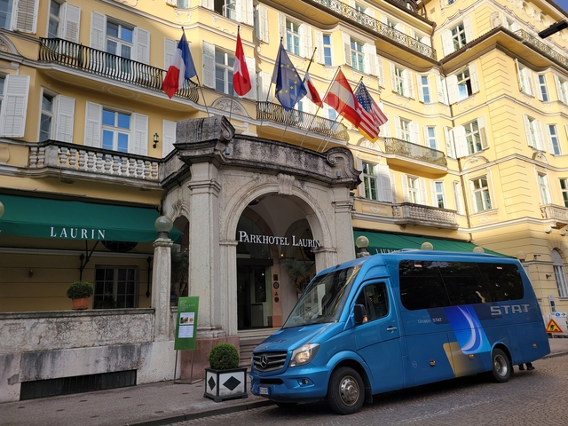 The facade of Parkhotel Laurin with a blue van parked outside.
