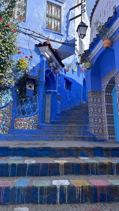 Vibrant blue walls of a stairway in a Moroccan city.