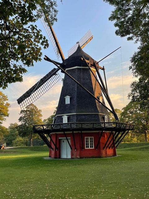Traditional windmill surrounded by trees.