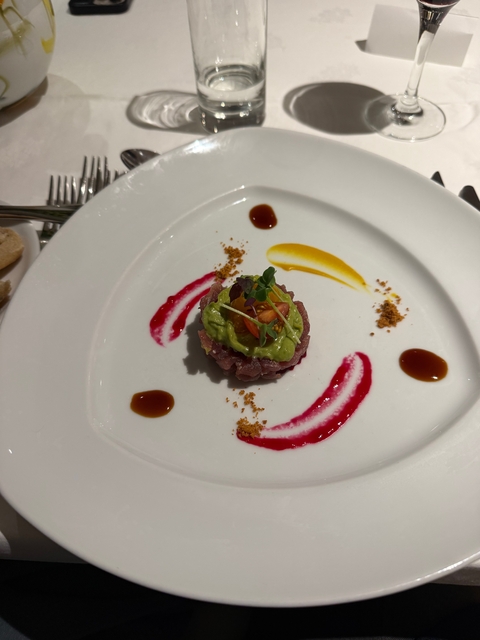 Gourmet fish dish with colorful garnishes