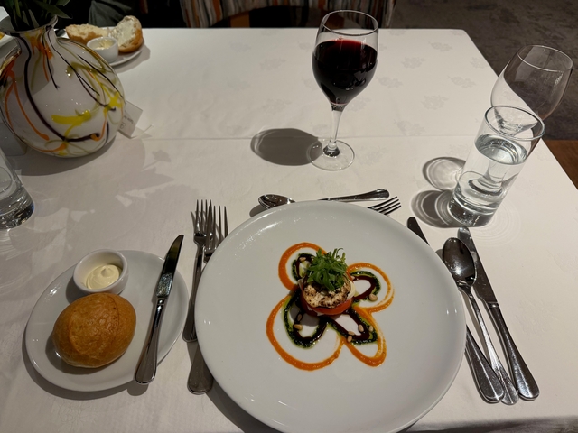 Gourmet appetizer with sauces and a glass of red wine