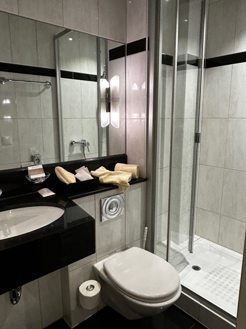 Modern bathroom sink and counter with amenities