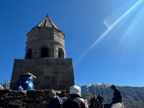       A historic tower among mountains.
  
