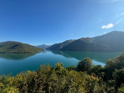       A scenic lake surrounded by mountains.
  