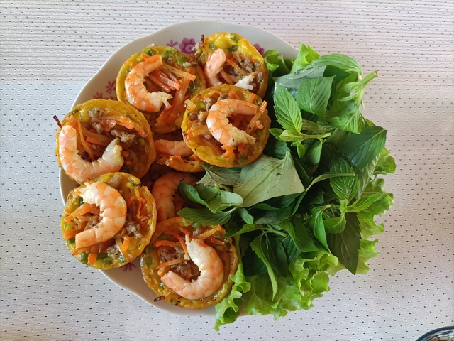       Plate of Vietnamese shrimp cakes with herbs.
  