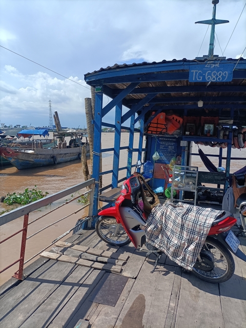       Boat dock with a motorcycle parked nearby.
  