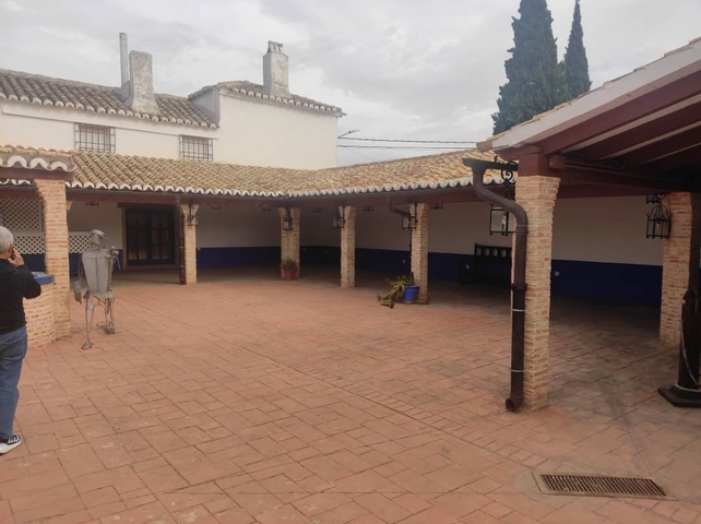 Open courtyard with a person taking photos.