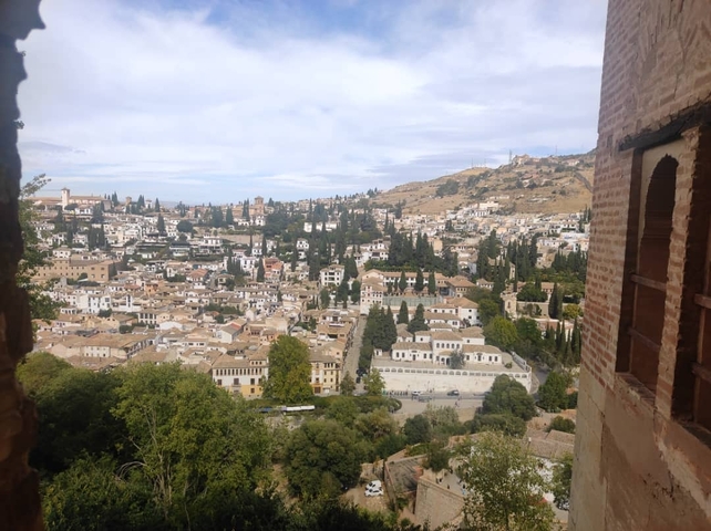 Scenic view of a city with rolling hills.