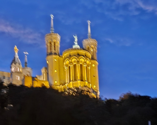 Blurred night-time view of a historic building.