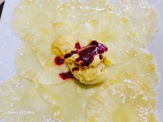 Close-up of dessert with ice cream and fruit.