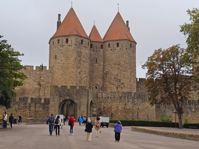 Medieval castle with people walking around.