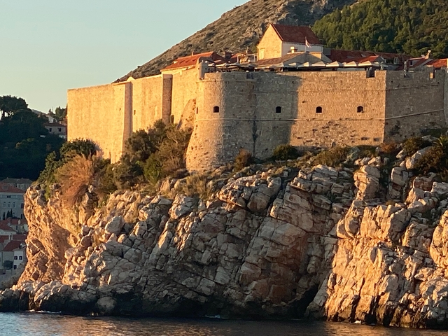View of ancient stone fortifications on a cliff.