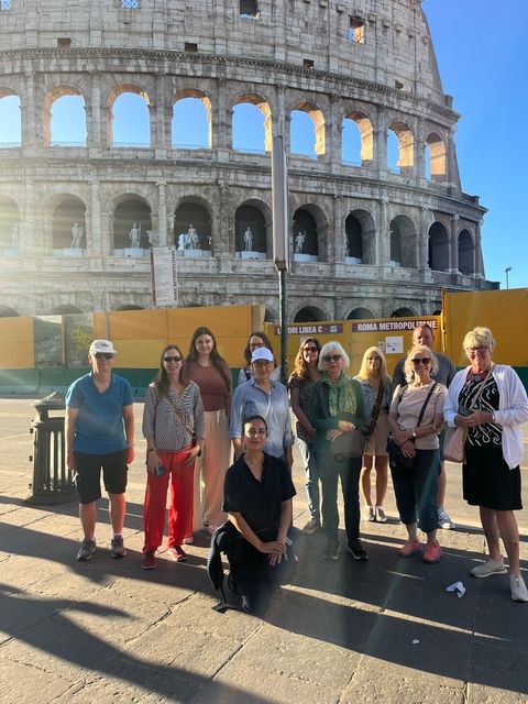 Group photo of people in front of the Colosseum