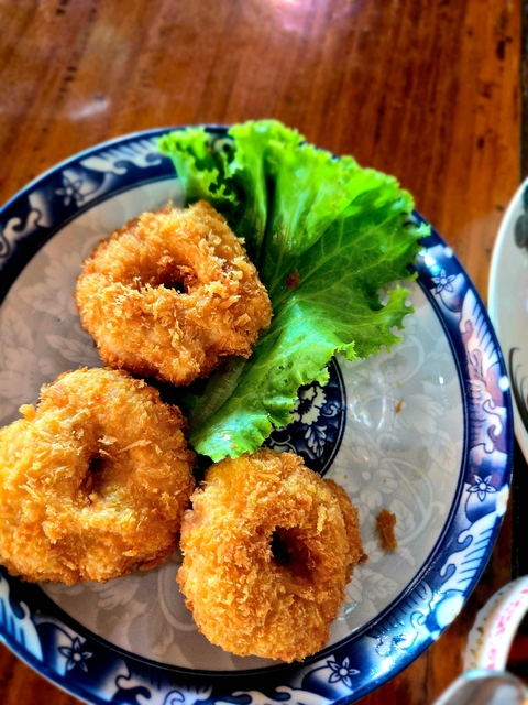 Fried food dish with a garnish of lettuce.