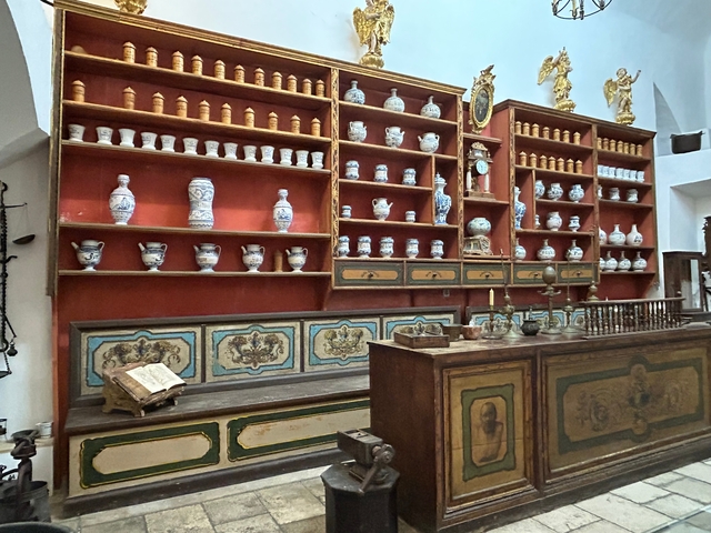       Interior of a vintage pharmacy filled with jars and bottles.
  