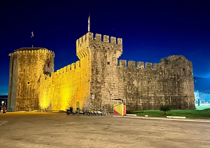       Illuminated old fortress at night.
  