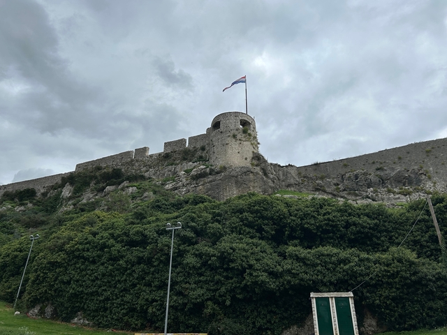       Fortified stone structure with a flag on top.
  