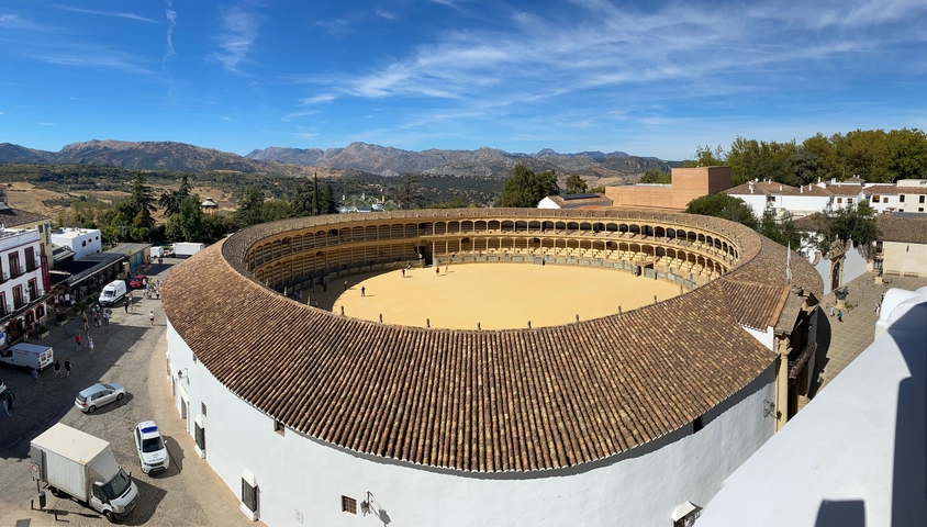       Aerial view of a historic bullring in a quaint town.
  