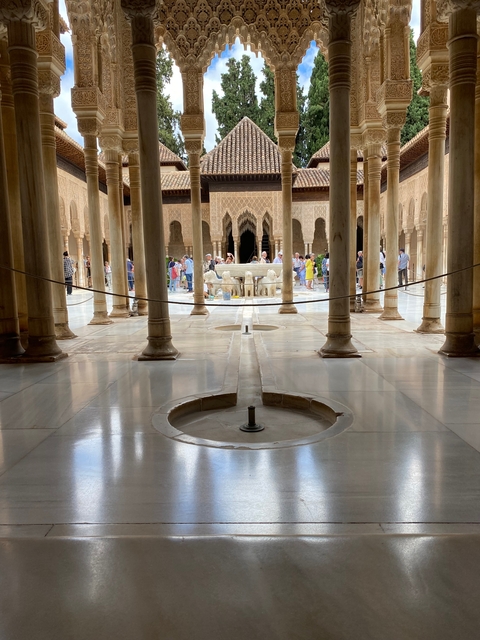       Visitors at a historic site with ornate columns.
  