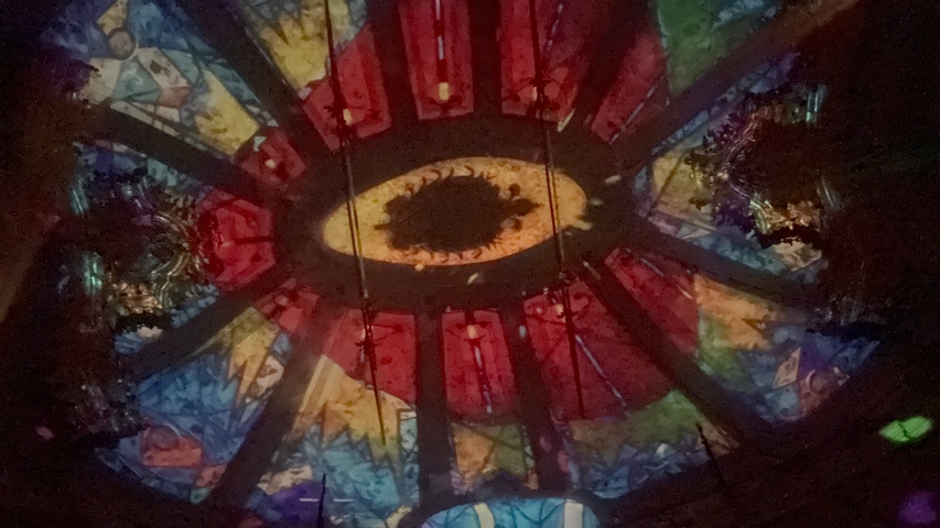 Colorful artistic ceiling in a dark room.