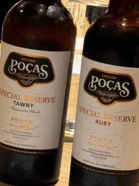Close-up of two wine bottles labeled Poças.