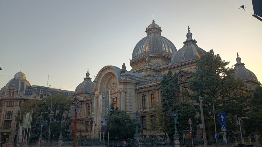       Imposing historical building with domes and arched entrance.
  