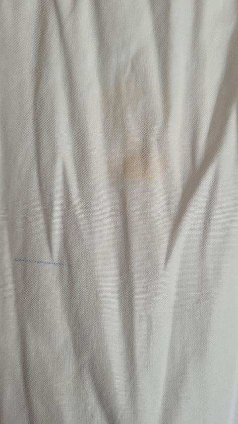 Textile with a small stain.