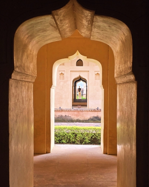 Architectural archways with view through to another arch.