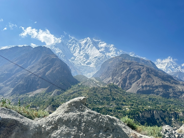 Snow-covered mountain peak above green valleys