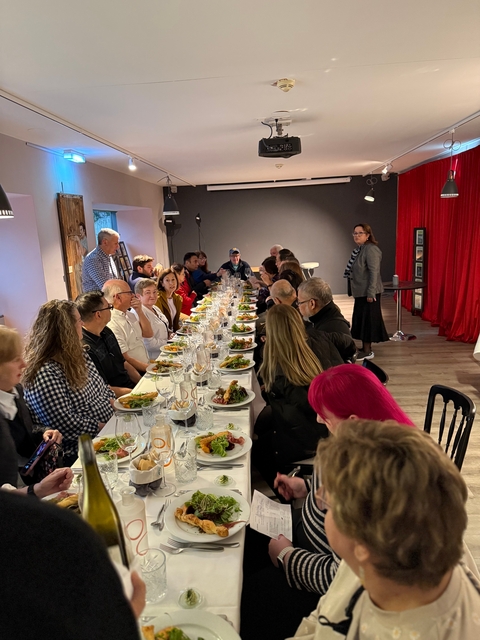 Group of people dining at a large table