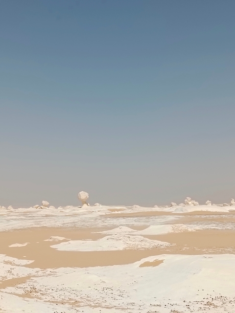       White desert landscape with unique rock formations.
  
