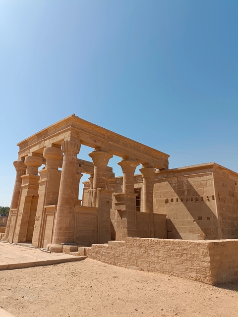      Ancient stone structures under a clear blue sky.
  