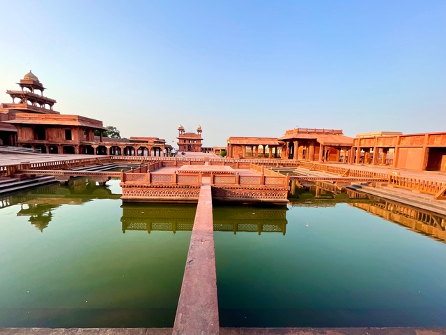       Architectural marvel with symmetrical design reflected in water.
  
