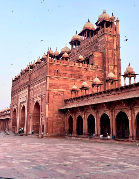 Intricate red sandstone architecture with domes.