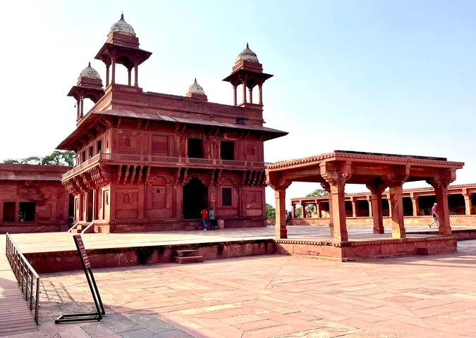 Palace courtyard with historical architecture and a prominent pavilion.
