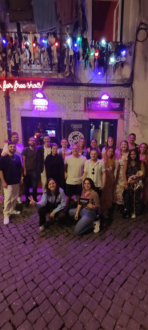 Large group of people posing in a dimly lit environment