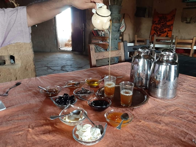 Traditional Moroccan breakfast setting with tea pour