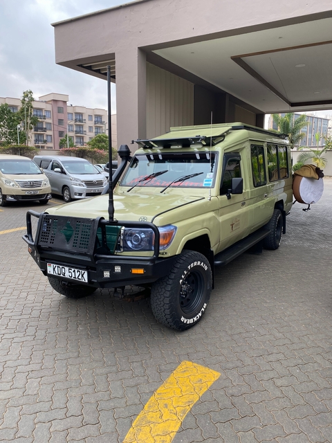       Parked safari vehicle in an urban area.
  